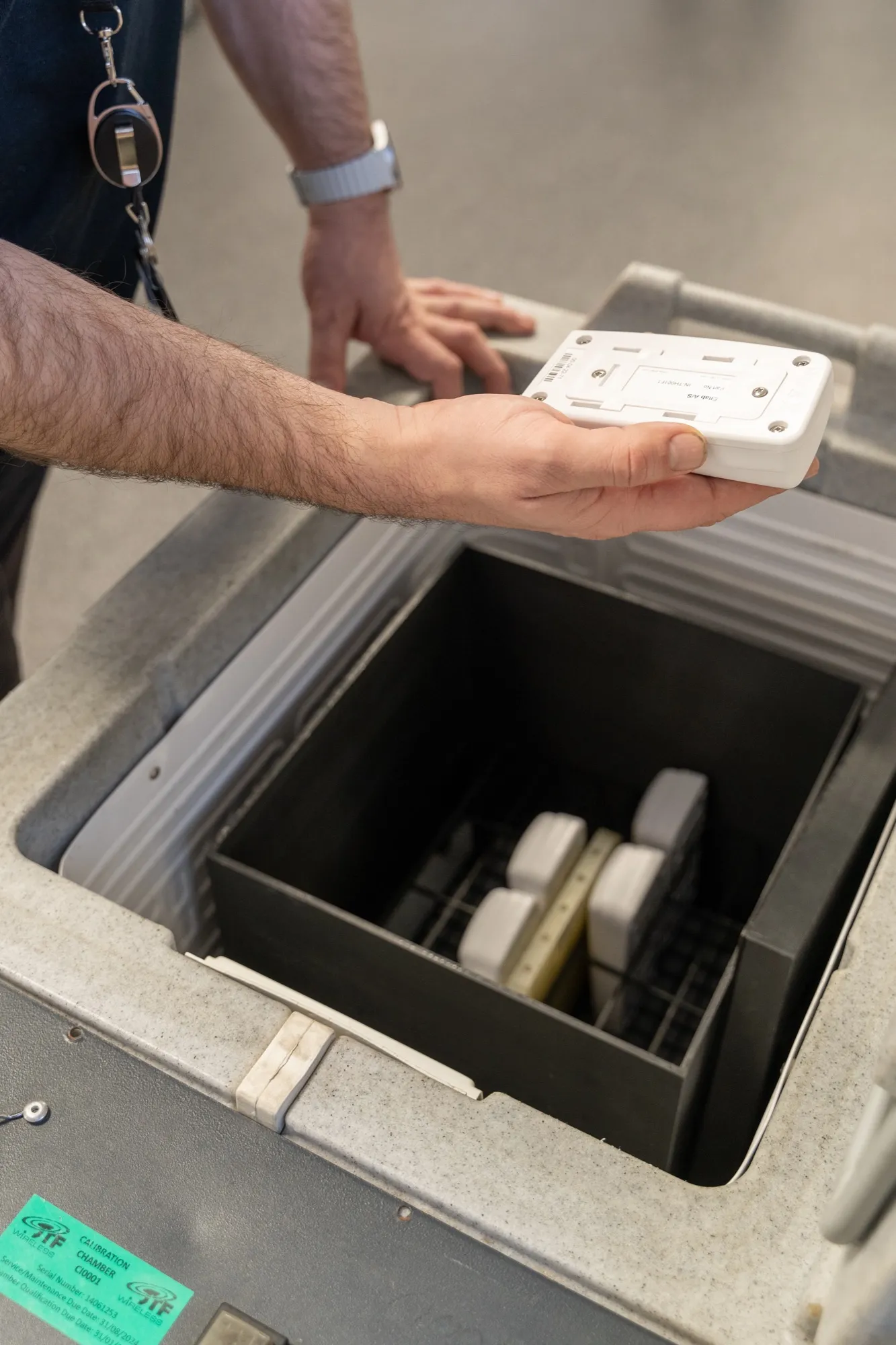 A JTF technician placing sensors in a calibration chamber