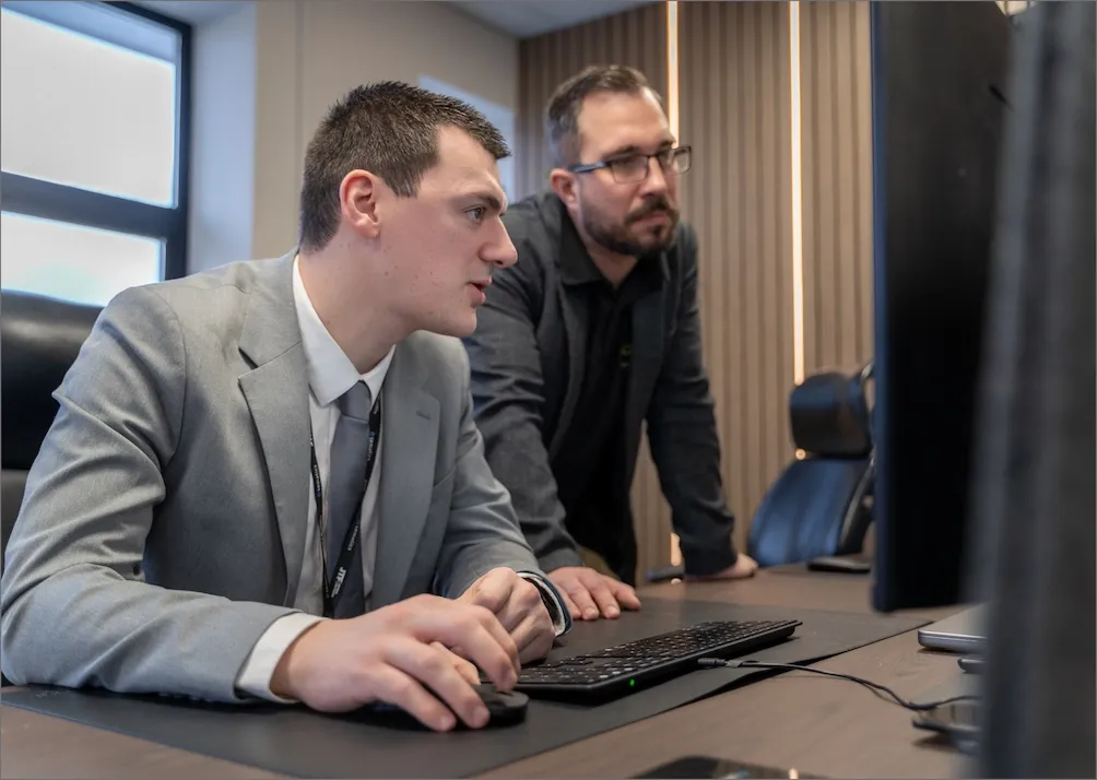 Two JTF engineers working together at a support workstation